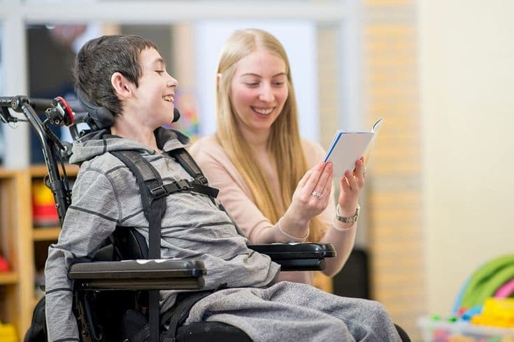 Support worker and participant working together in a warm, everyday setting