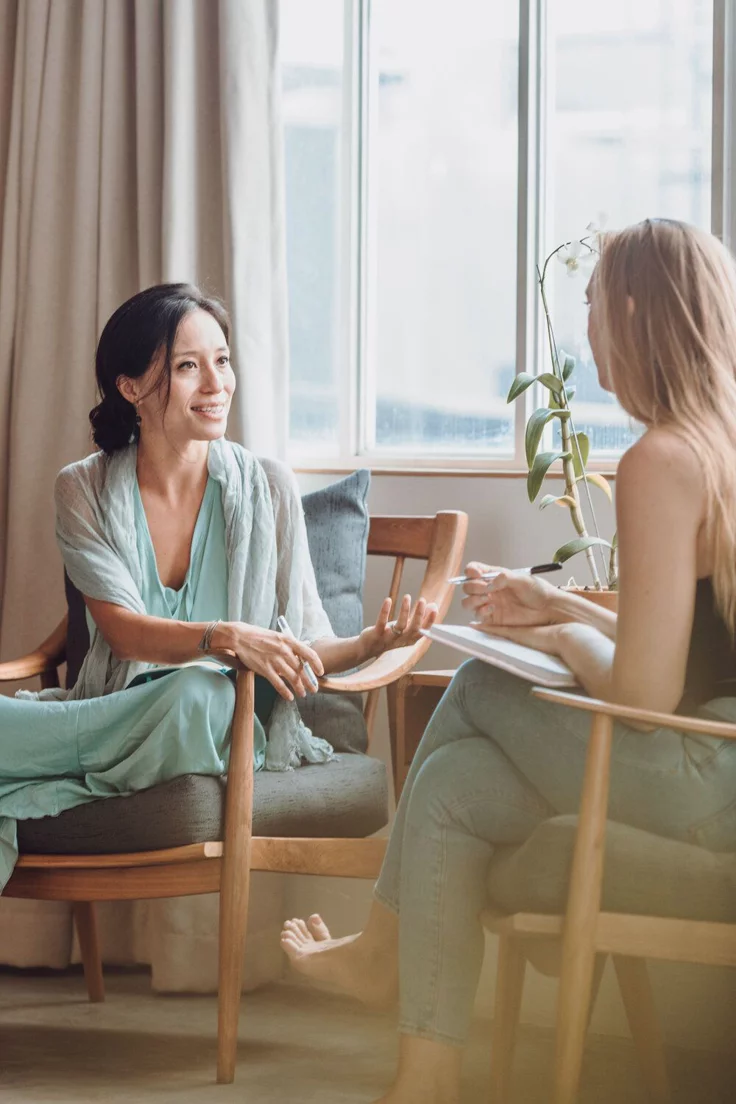 A support coordinator in conversation with a colleague